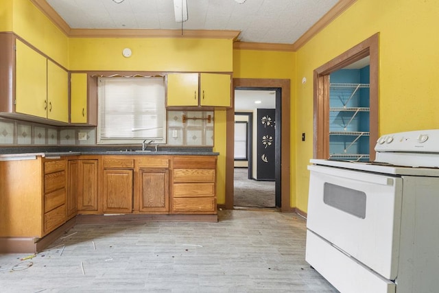 kitchen with dark countertops, ornamental molding, white electric range, light wood-style floors, and a sink