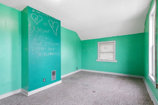 bonus room featuring vaulted ceiling, carpet, and baseboards