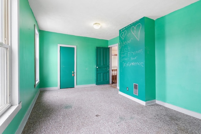 unfurnished bedroom with baseboards, visible vents, and carpet flooring