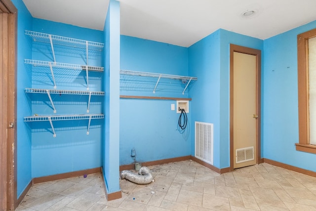 laundry room with laundry area, baseboards, visible vents, and washer hookup