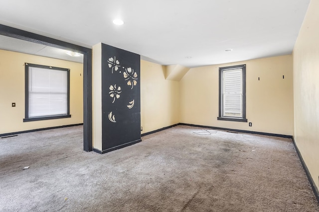 unfurnished room with light colored carpet, visible vents, and baseboards