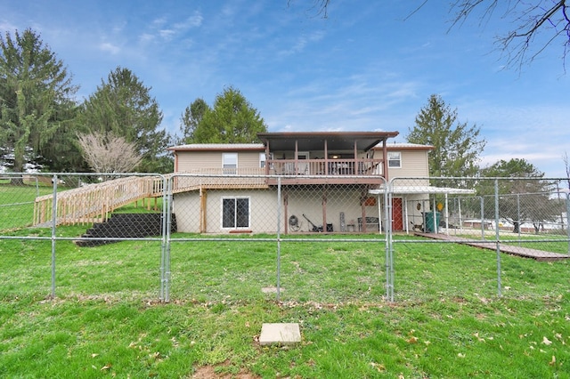 rear view of property featuring a yard and fence