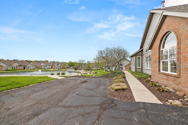 view of street featuring a water view and a residential view