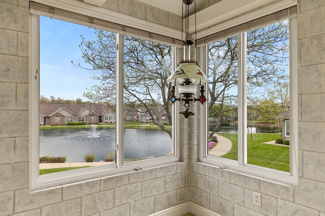 unfurnished sunroom featuring a water view and plenty of natural light