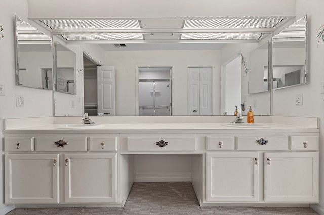 bathroom featuring a sink and double vanity