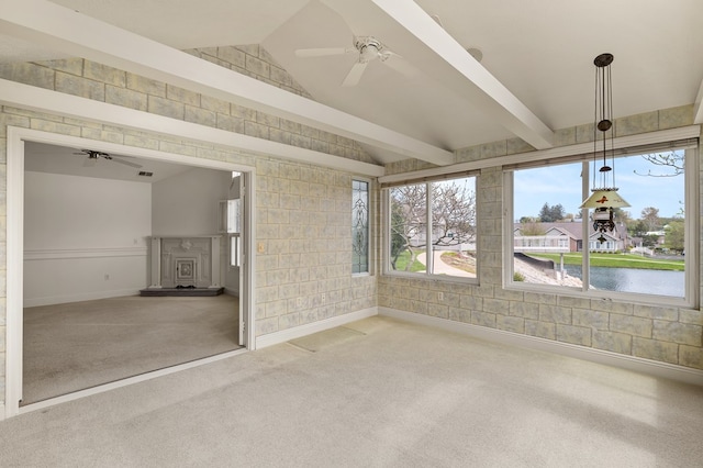 unfurnished sunroom featuring a water view, beam ceiling, and a wealth of natural light