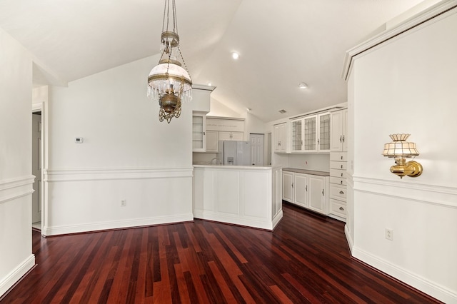 kitchen featuring stainless steel fridge with ice dispenser, dark wood-style flooring, a peninsula, and lofted ceiling
