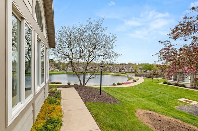 view of yard with a water view and a residential view