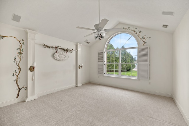 empty room featuring visible vents, ceiling fan, lofted ceiling, and light carpet