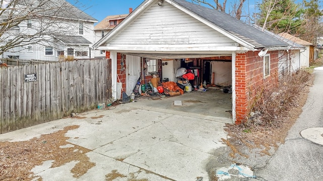 detached garage featuring fence