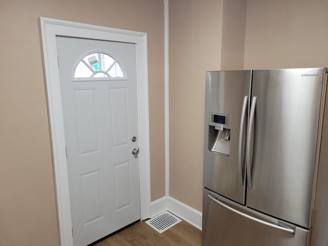 interior space featuring light wood-type flooring, visible vents, and baseboards