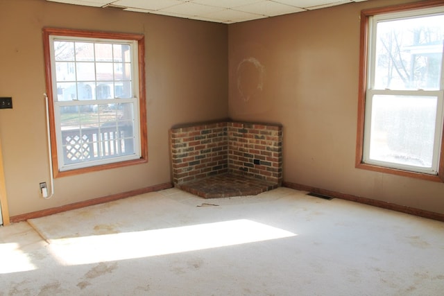 unfurnished room featuring light carpet