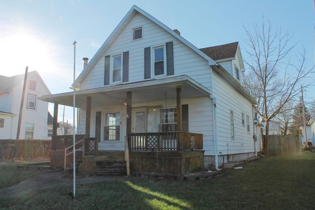 view of front of house featuring a front lawn and covered porch