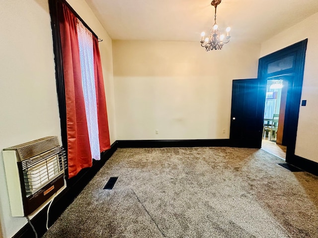 carpeted spare room with heating unit and a notable chandelier