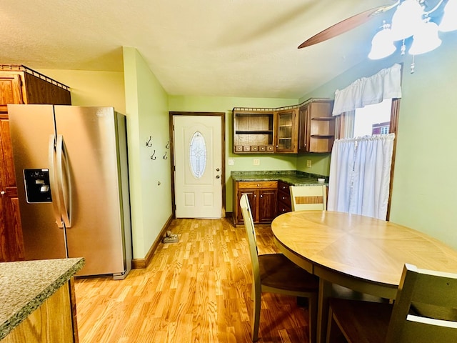 kitchen featuring ceiling fan, stainless steel refrigerator with ice dispenser, and light wood-type flooring