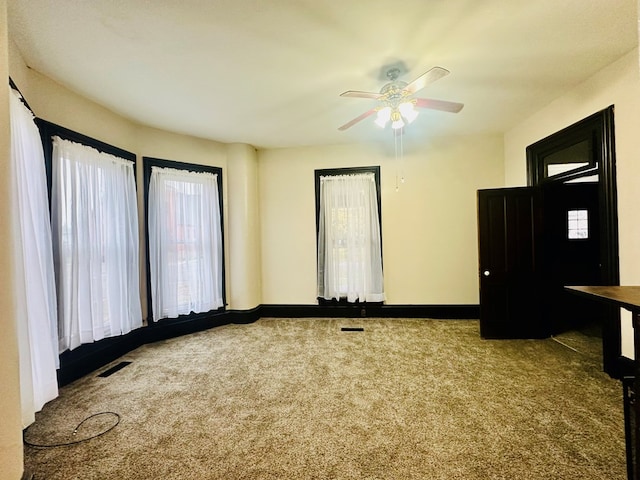 carpeted empty room with ceiling fan