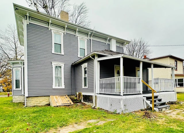 rear view of house featuring a porch