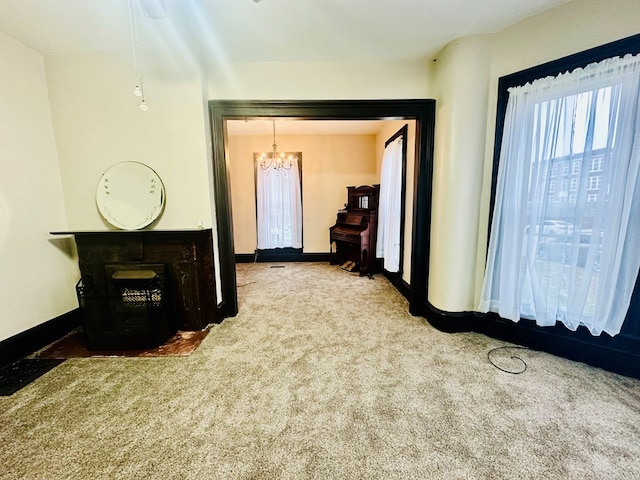 hallway featuring carpet floors and a notable chandelier