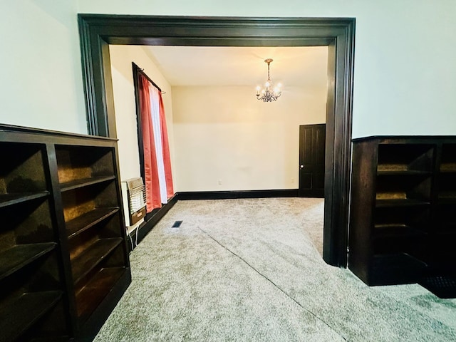 corridor featuring a chandelier, carpet floors, and heating unit