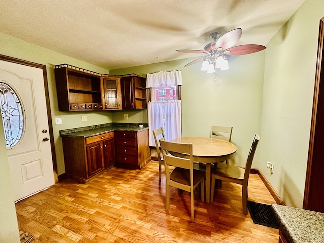 dining area featuring ceiling fan and light wood-type flooring