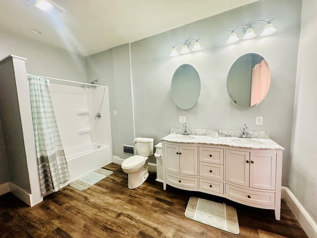 full bathroom featuring vanity, wood-type flooring, shower / tub combo, and toilet