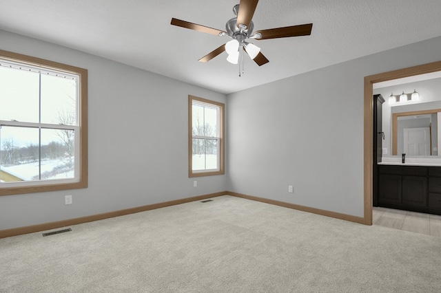 113 Gables Blvd, Lexington, OH 44904 - unfurnished bedroom with ensuite bath, light carpet, baseboards, and visible vents