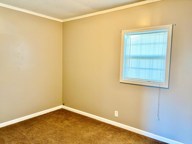 spare room with dark carpet, a textured ceiling, baseboards, and ornamental molding