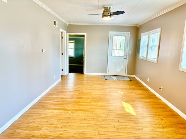 foyer entrance with a wealth of natural light, visible vents, light wood finished floors, and ceiling fan