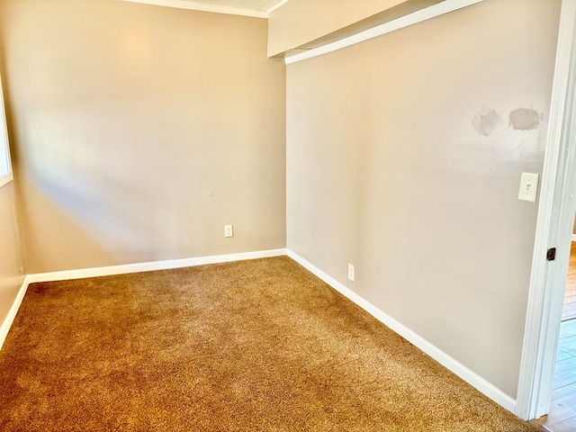 unfurnished room featuring baseboards and carpet