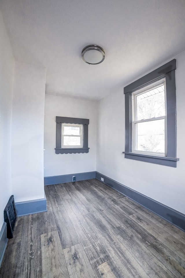 spare room featuring dark wood-type flooring