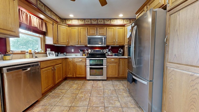 135 W Smiley Ave, Shelby, OH 44875 - kitchen featuring stainless steel appliances, light countertops, ceiling fan, and brown cabinets
