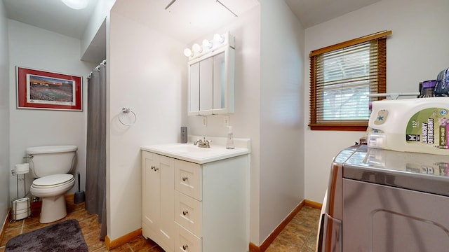 135 W Smiley Ave, Shelby, OH 44875 - bathroom featuring vanity, washer / dryer, and stone finish floors