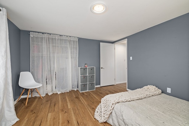 bedroom with hardwood / wood-style flooring