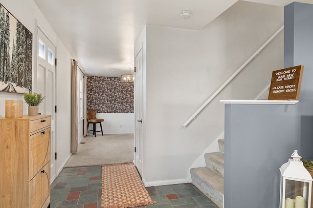 stairs featuring carpet and a notable chandelier