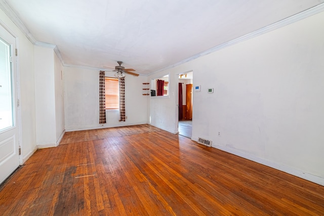 empty room featuring plenty of natural light, crown molding, hardwood / wood-style flooring, and ceiling fan