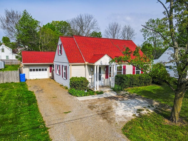 cape cod home featuring fence, a garage, a front lawn, and aphalt driveway