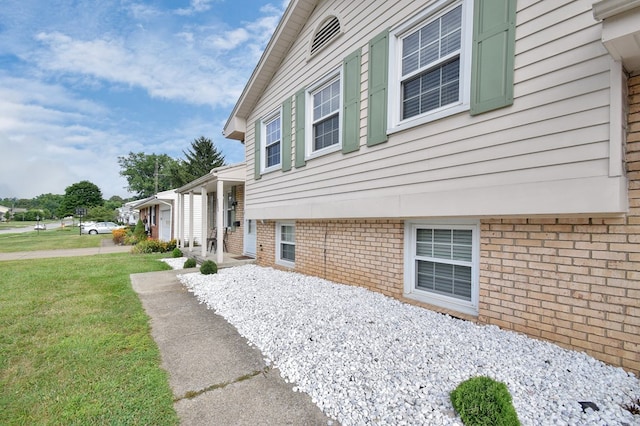 view of property exterior with a lawn