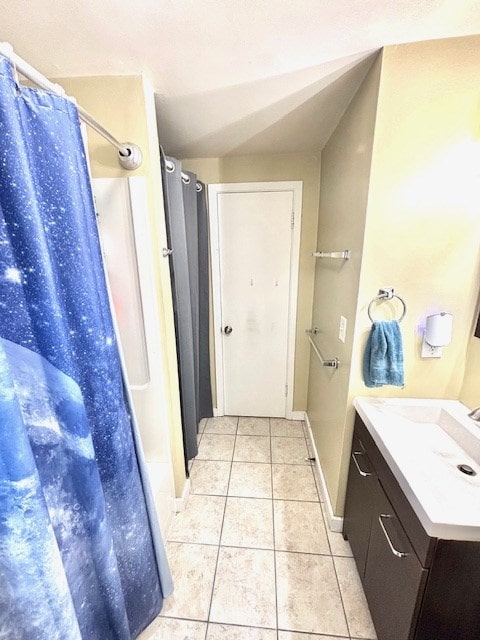full bathroom featuring curtained shower, baseboards, tile patterned flooring, and vanity
