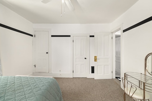 carpeted bedroom with a ceiling fan, visible vents, and a closet