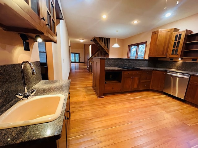 kitchen with stainless steel dishwasher, light wood-style flooring, open shelves, brown cabinets, and a sink