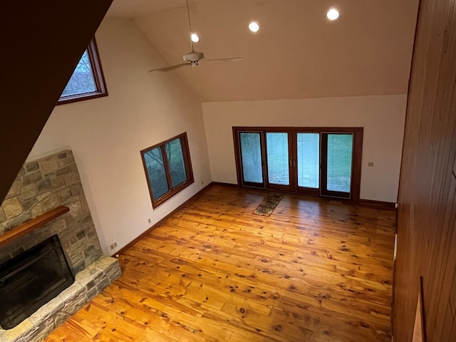 unfurnished living room featuring recessed lighting, a fireplace, wood-type flooring, high vaulted ceiling, and a ceiling fan