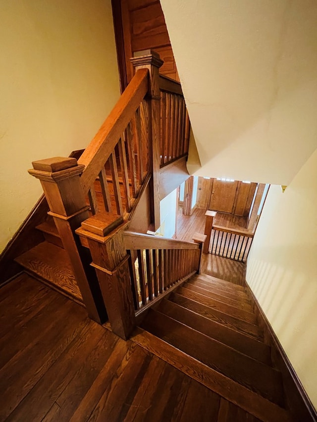 stairs featuring hardwood / wood-style flooring