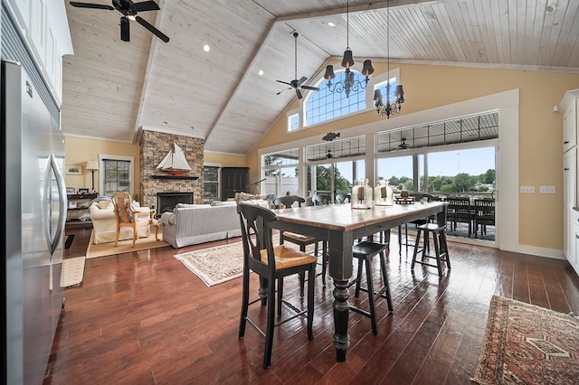 7326 State Route 19, Mount Gilead, OH 43338 - dining area with ceiling fan, a stone fireplace, dark wood finished floors, high vaulted ceiling, and a chandelier