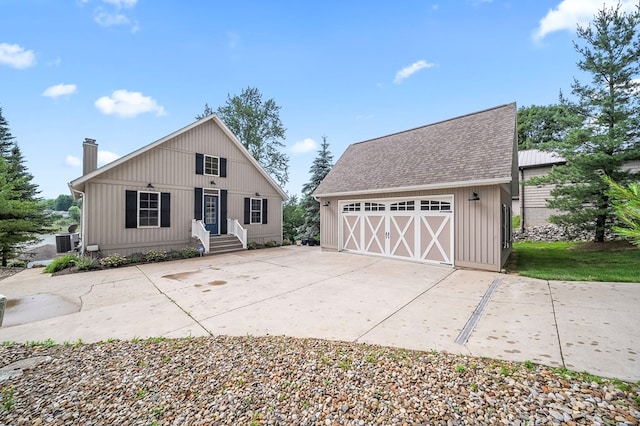 7326 State Route 19, Mount Gilead, OH 43338 - view of front of property featuring a detached garage, a chimney, an outdoor structure, a shingled roof, and entry steps