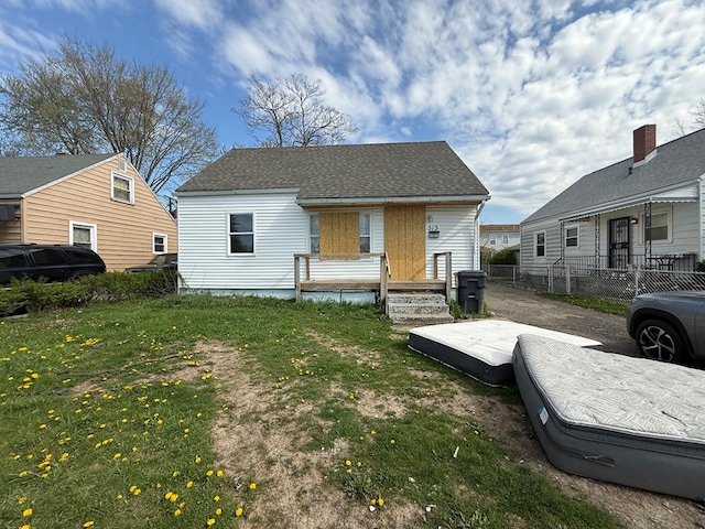 bungalow-style house with fence and a front yard