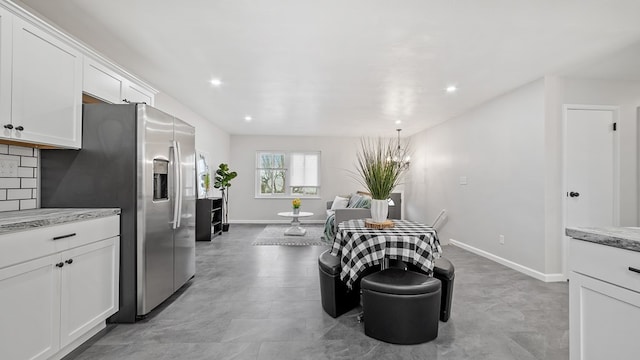 dining space with recessed lighting and baseboards