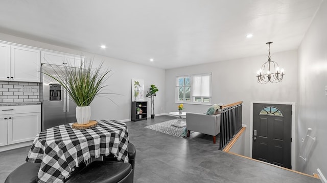 dining space with a chandelier, recessed lighting, and baseboards