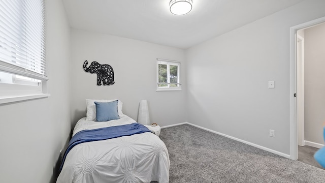 bedroom featuring carpet flooring and baseboards