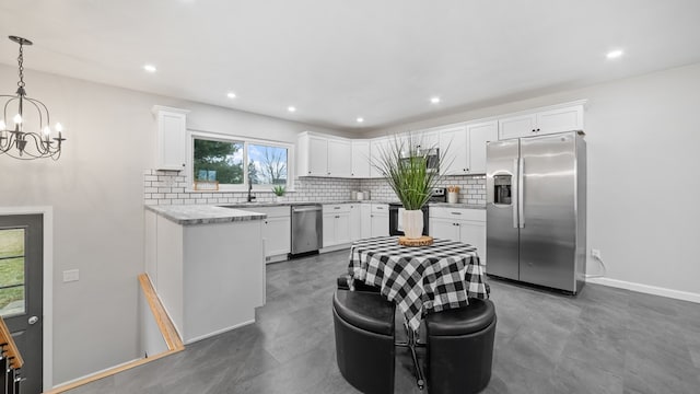 kitchen featuring backsplash, stainless steel fridge, white cabinetry, and pendant lighting