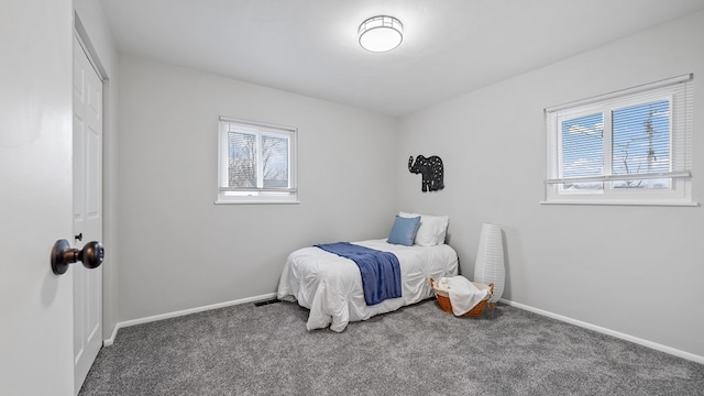 bedroom with multiple windows, baseboards, and dark colored carpet